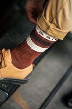 Step up your sock game with our Rust striped socks, designed to bring both comfort and retro flair to your everyday wear. Inspired by the bold skateboarder style of the ‘70s, these socks blend style, fit, and durability into one perfect pair. Crafted from a carefully selected mix of yarns, these socks offer a comfortable, snug fit that stays in place, thanks to the ribbed calves. The &SONS woven jacquard logo sits just below the cuff, adding a subtle nod to our brand’s pioneering spirit. Whether Skateboarder Style, Skateboard Fashion, Sock Game, Skateboarder, Striped Socks, The 70s, Step Up, Stay Warm, Snug Fit