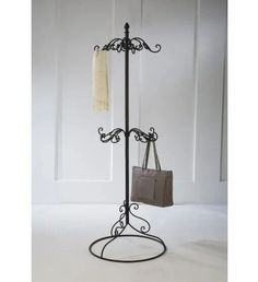 a coat rack with a purse on it and a handbag hanging from the top