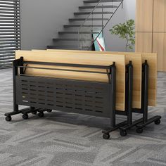 an office desk with wheels on the floor next to a stair case and bookcase