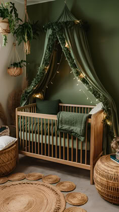 a baby's room decorated in green and gold with plants hanging from the ceiling