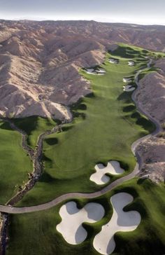 an aerial view of a golf course in the mountains