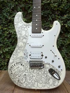 a white guitar with black and white designs on it