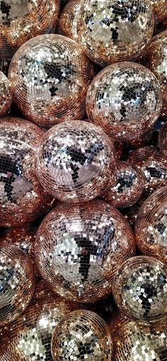 many shiny disco balls are stacked on top of each other