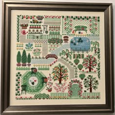 a cross stitch pattern with trees and houses