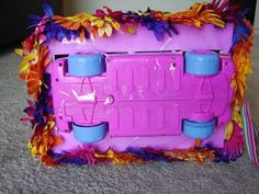 a pink and blue toy oven sitting on top of a carpeted floor next to a wall