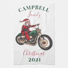 a white towel with a santa clause riding on a motorcycle and the words campbell family christmas