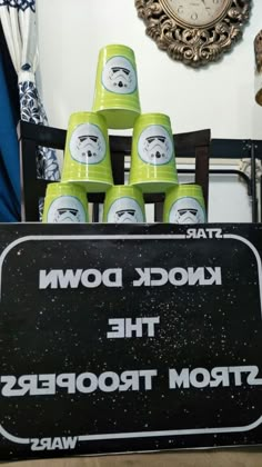 a star wars themed party with green cups in the shape of faces and text that reads knock down the storm troopers