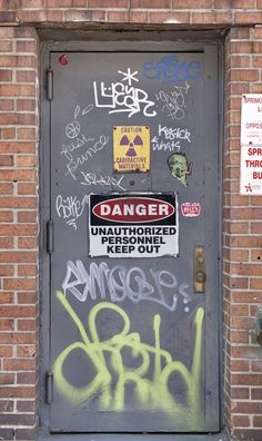 the door is covered with graffiti and stickers