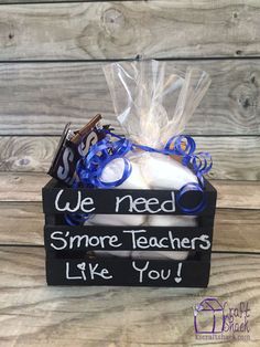 a small box with some kind of teacher's stuff in it on top of a wooden