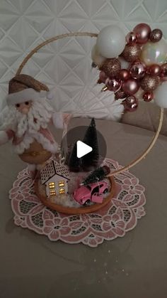 a christmas scene with santa claus and other decorations on a table top, in front of an ornament