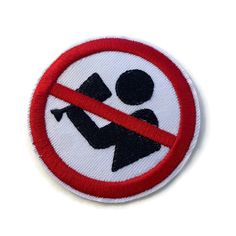 a red and white patch with a black silhouette of a person holding a baby in it's arms