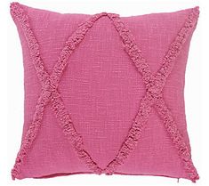 a pink pillow with tassels on the front and back side, sitting on a white background