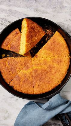 a skillet filled with cornbread on top of a table