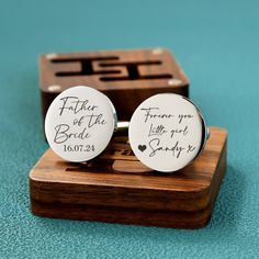 two personalized cufflinks with the words father of the bride written on them