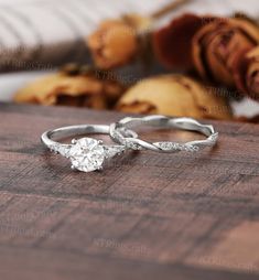 an engagement ring on top of a wooden table