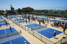 many people are playing tennis on an outdoor court