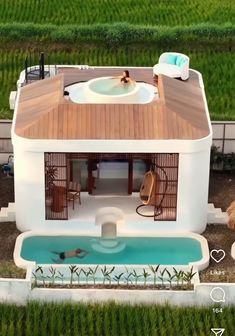 an aerial view of a small house with a pool and hot tub in the yard