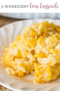 a white plate topped with corn casserole on top of a wooden table