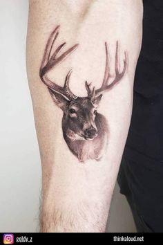 a man's arm with a deer tattoo on it