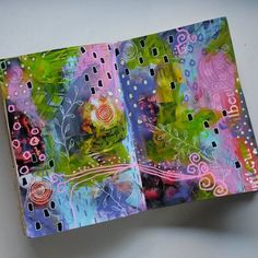 an open book with colorful designs on it