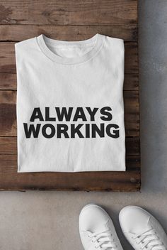 Looking for a quirky and fun t-shirt to showcase your hard-working personality? Check out our Always Working text t-shirt! Made with soft, high-quality cotton, this unisex tee is perfect for casual wear, office parties, or as a gift for your workaholic friends. Featuring a trendy slogan and stylish font, our Always Working shirt is designed to be both comfortable and eye-catching. The pre-shrunk fabric ensures a great fit, and the durable print will last through countless washes. Stay motivated Text T Shirt, Text Tee, Counting Cards, Quote Tees, Mothers Day Shirts, Blackjack, Unisex Tshirt, Text Design, Shirts With Sayings