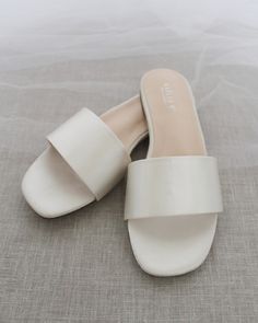 Classic slide flat sandals for casual and dressy look. Simple and easy wear for brides, bridesmaids and wedding parties.DETAILS:COLORS AVAILABLE: Ivory, Light Blue, White, Pink, and ChampagneUPPER: Synthetic upper and liningMATERIALS: Mandmade outsole STYLE NAME: EVELYN Flats For Wedding, Name Evelyn, Bridesmaid Sandals, Ivory Flats, Wedding After Party, Slip On Sandals, Wedding Parties, Satin Slip, Dress Ideas