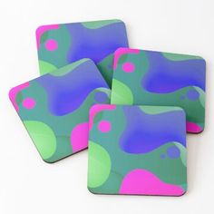 four coasters with pink, green and blue designs on the top one is square