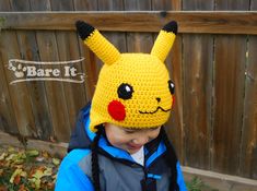 a young boy wearing a crocheted pikachu hat