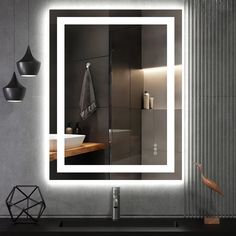 a bathroom with a large mirror on the wall and lights above it that illuminates light