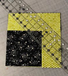 a patchwork quilt with black and yellow squares