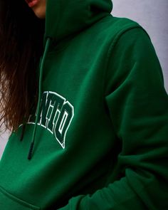 a woman wearing a green hoodie with the word don't on it in white