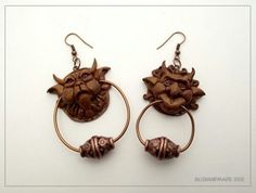 the earrings are made out of wood and have an elephant head on it's ear