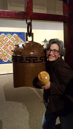 a woman is holding a large object in her hand