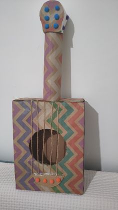 a cardboard box with an animal in it's mouth and string wrapped around the top