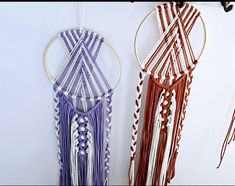 two different colored macrame hangings on a wall