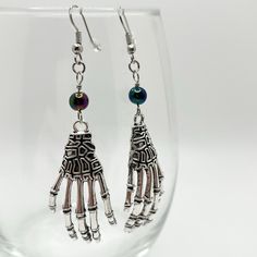 Halloween-themed skeleton hand earrings 💀 - silver colored wire - dark multi-colored beads - charm is metal  I do not accept returns or exchanges Skeleton Accessories, Skeleton Jewelry, Halloween Skeleton Hand, Hand Earrings, Skeleton Costume, Beads Charm, Earrings Halloween, Skeleton Hand, Halloween Skeleton