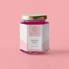 a jar of pink honey on a pink background