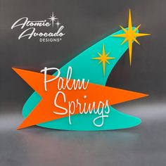 an orange and blue sign that says palm springs on it's side with stars in the background