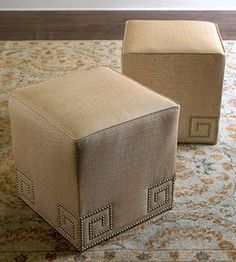 two small stools sitting on top of a carpeted floor next to each other