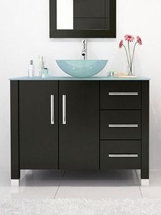 a bathroom vanity with a blue bowl sink