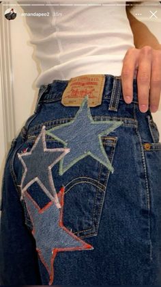 a woman's jeans with stars painted on them