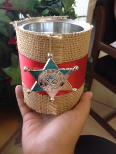 a person is holding a red and green coffee cup with a star on the top