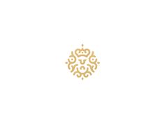 a white and gold logo with an ornate design in the shape of a lion's head