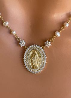 "This 14k gold-filled Virgin Mary pendant necklace with freshwater pearls approximately 3-3.5mm. Spring clasp on back. Mary pendant measures 20mm and has clear pave crystals. Model is wearing a 15\" length in photos. Necklace comes in many lengths, choose your length. Comes in a gift box ready to present!" Luxury Pearl Pendant Necklaces For Weddings, Luxury Bridal Necklace With Pearl Charm As Gift, Gold Royalty Necklace, Spiritual Jewelry The Catholic Company, Necklace For Sweet 15, Quinceanera Necklace Mexican, Luxury Victorian Cross Necklace, Quinceanera Necklace Elegant, Luxury Crucifix Necklace For Formal Occasions