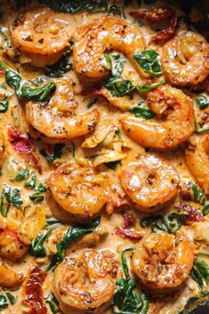 a skillet filled with shrimp and spinach