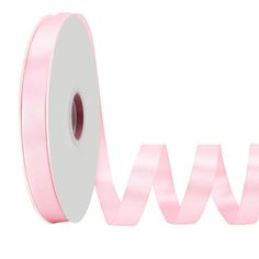 a roll of pink satin ribbon on a white background