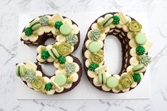 a cake shaped to look like the number 50 is decorated with green and white icing