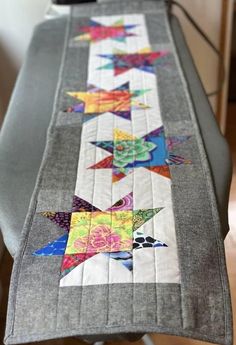 an ironing board with a quilted star design on it