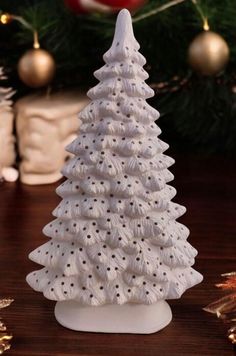 a white ceramic christmas tree sitting on top of a table