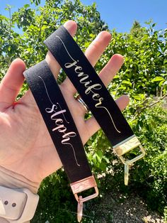 someone is holding up two black straps with the words love and strength written on them